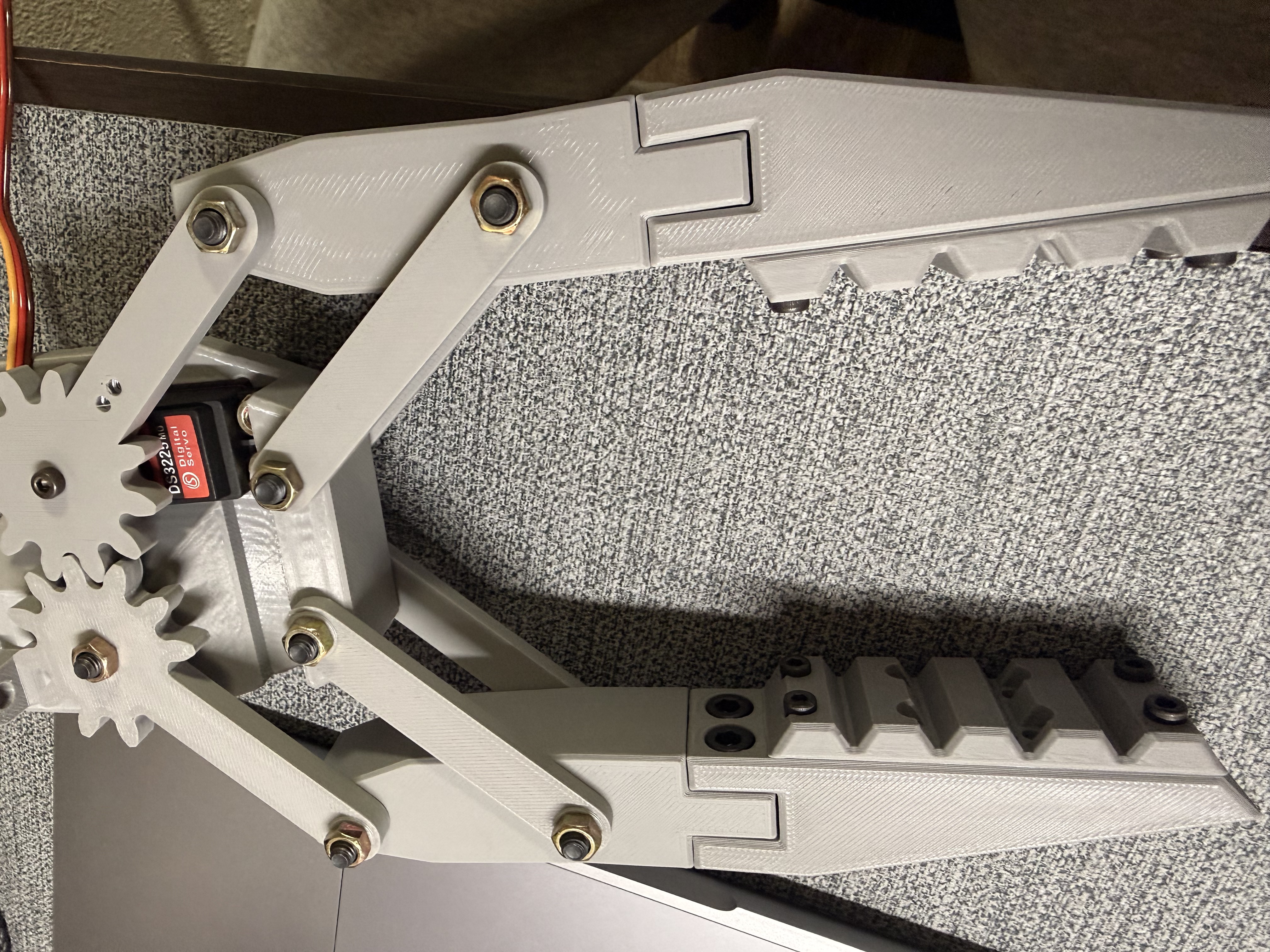 Ray's assembled 3D-printed gripper with a DS3225MG servo, gears, and jaw linkages